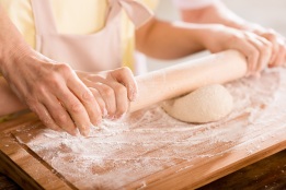 Grandmother and grandchild kneading dough